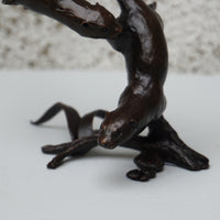 solid bronze sculpture of two otters swimming